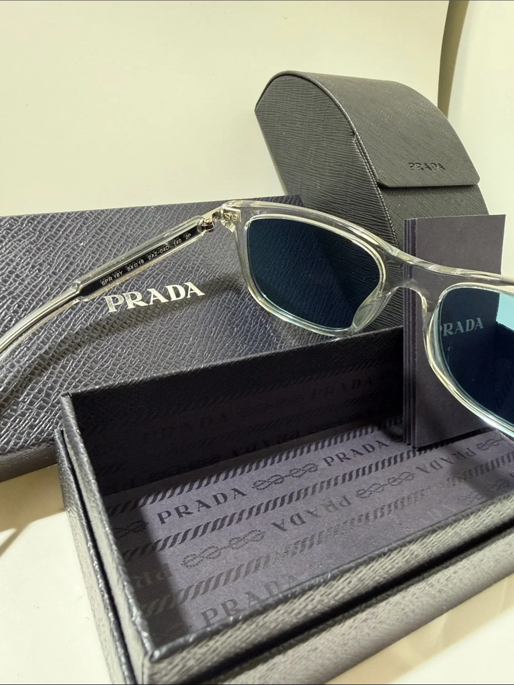 Prada Clear Frame Sunglasses with Blue Lenses